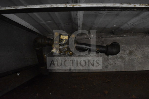 Jade gas powered commercial cheese melter in used condition, visible piping, and gas regulator.