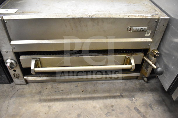 Jade gas-powered commercial cheese melter, stainless steel, used condition, front controls, and adjustable handle.
