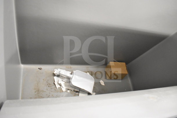 Scotsman B948S 48" Ice Bin, 893 lbs capacity, scratch and dent condition. Interior with white scoop and cardboard box.
