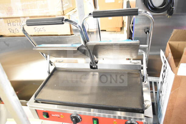 Brand new Avantco 177PG400S commercial dual panini grill, smooth plates, 19 5/8" x 9 1/8" surface, 120V, slight cosmetic dents.