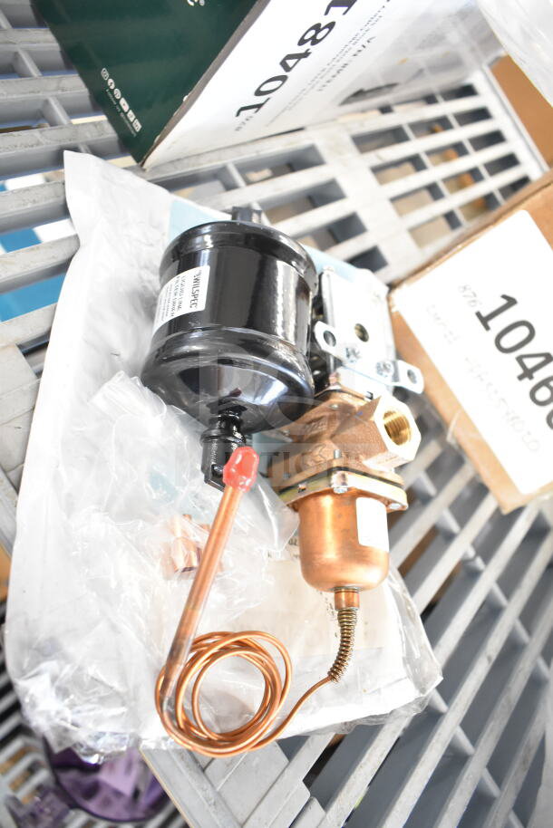 2 new items: Ice-O-Matic 9041059-101 water regulator kit and Scotsman A32588-020 pump. Seen with labels, in packaging.