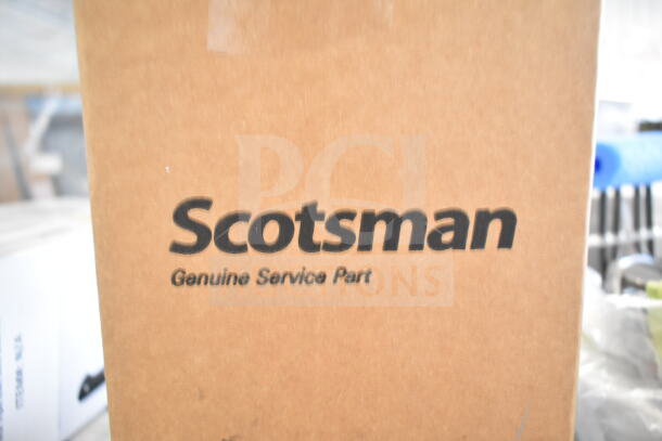 Cardboard box labeled "Scotsman Genuine Service Part" containing item from auction listing.