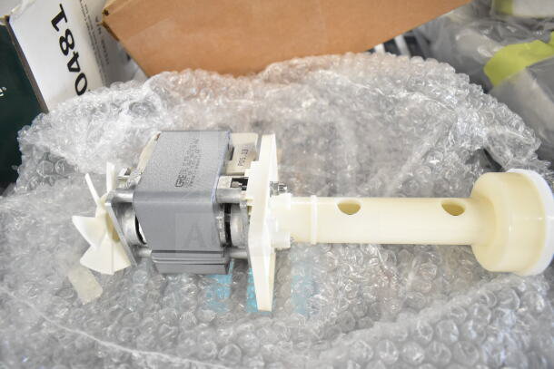 Brand new Ice-O-Matic 9041059-101 OEM Kit and Scotsman A32588-020 Pump, both scratch and dent, on bubble wrap.