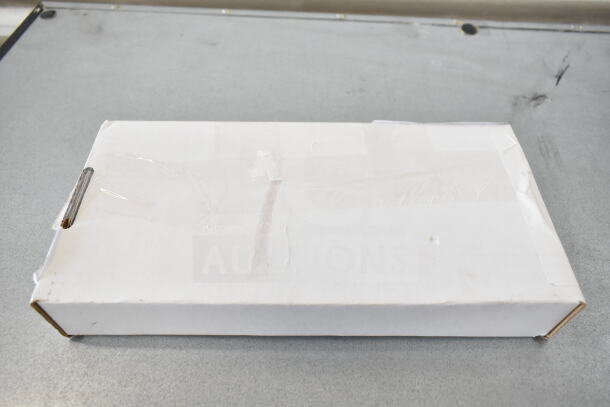 White cardboard box containing brand new items, including Zumex shredder disc, Lincoln digital board, soap dispenser, and Vollrath pusher head.