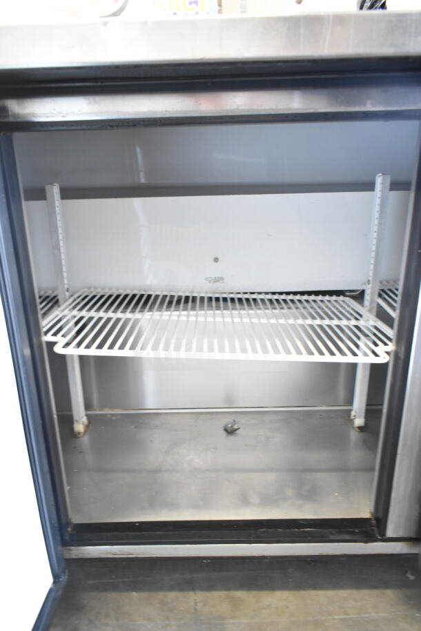 True TUC-72 commercial 3-door undercounter cooler with shelves. Features commercial casters. 115 volts, 1 phase.