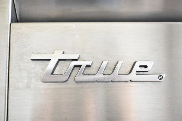 True logo on the 2021 STG1F-2HSLH-HC Commercial 2 Half Size Door Reach In Freezer, featuring stainless steel finish.