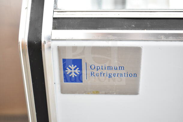 Optimum HD-72 commercial deli display case. Features Optimum branding, uses 120 volts, 1 phase. Visible wear on surface.