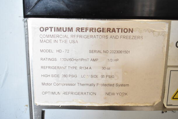 Optimum HD-72 deli display case label showing model, serial number, and specifications, including 120V, 1/3 HP.