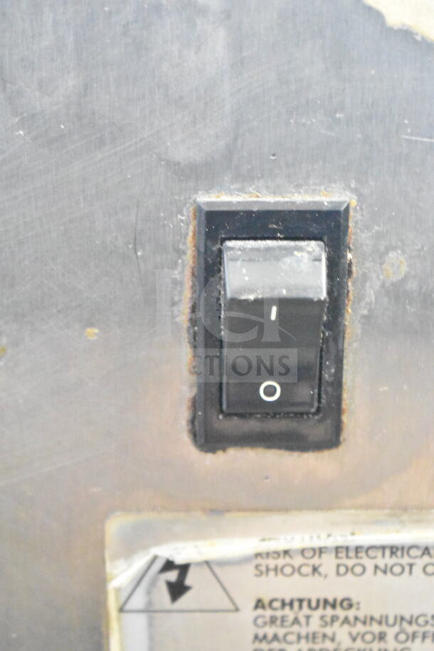 Alto Shaam 750-TH/III oven power switch with "I/O" markings, showing slight rust and warning label below for electrical shock.