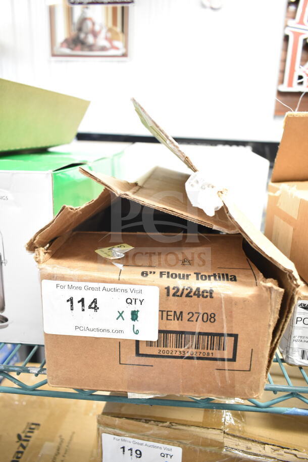 Cardboard box with visible labels indicating auction lot number 114, containing 6 new Choice 220KSLCS10YW 10" serrated knives.
