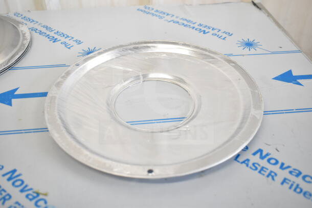Metallic circular plate, new condition, packaged in plastic wrap. Part of 17-item scratch and dent lot for auction.
