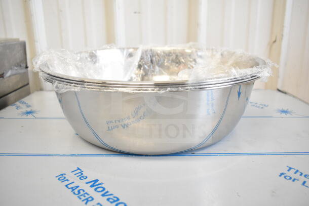 Stainless steel bowl wrapped in plastic, part of a 17-item scratch and dent lot including a collar form.