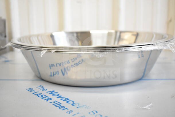 Stainless steel bowl, brand new, with protective wrap, part of a 17-item scratch and dent auction lot.