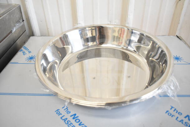 Shiny new stainless steel bowl, reflective surface, pristine condition. Part of 17 scratch-and-dent auction items.