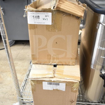 Two unopened cardboard boxes containing scratch and dent ServSense condiment dispensers, marked as 651PDS2QT3P and 651PDS2QT5P.
