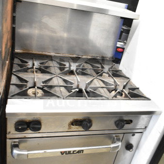 Vulcan 36S-Y1A commercial 6-burner gas range with oven, overshelf, and backsplash. Used condition, visible signs of wear.