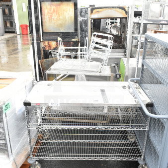 BRAND NEW Metro GG2448 24" x 48" stainless steel workstation cart, scratch and dent, with "Breakfast On the Go" sign.