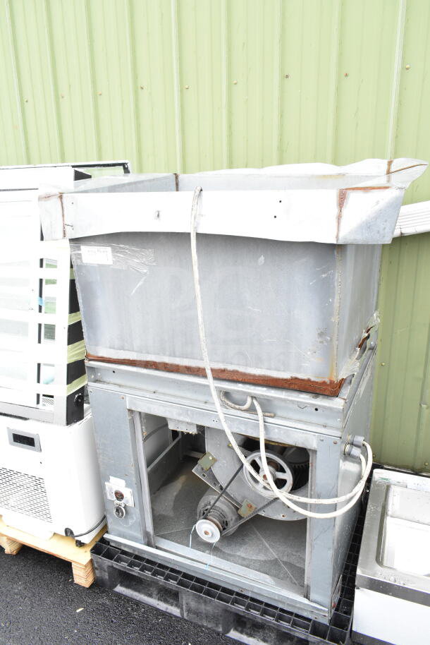 Commercial floor style unit with exposed wiring and pulley system, moderate wear, visible rust, mounted on a pallet.