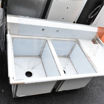 Brand new Regency 600S2182418R two-compartment commercial sink, 58.5", with galvanized steel legs, 18" right drainboard. Scratch and dent condition.