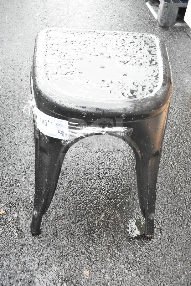 Gray Tolix style metal stool, brand new with some scratches and dents. Visible label "183/16 OFF X4". Elegant industrial design.