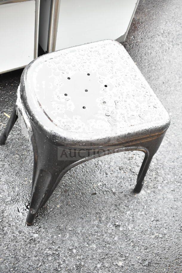 Gray Tolix-style stool with a scratched and dented surface. Designed with drainage holes. Brand new condition.