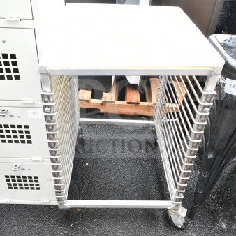 Commercial pan transport rack with shelves, on heavy-duty casters. Used condition, stainless steel, suitable for kitchen use.