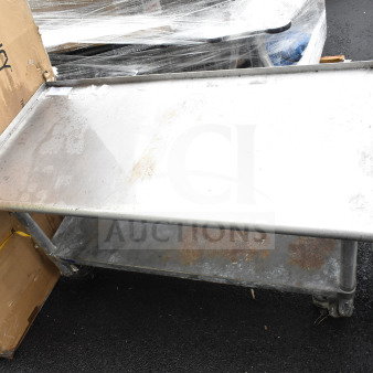 Commercial equipment stand with under shelf, metal construction, used condition, visible wear, ideal for industrial use.