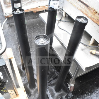 Five metal table base columns with mounting plates, in good condition. Tags indicate item number 193. Auction lot.