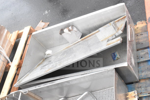 Two metal bins with contents on a wooden pallet, featuring handles. Slight rust and wear visible.