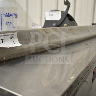 Stainless steel ticket rack, wrapped and labeled as item 217, showing light wear. Ideal for organizing tickets.