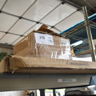 Box of 9 new scratch and dent items, including 190FG2418 stainless steel splash guard for deep fryers, on a shelf.