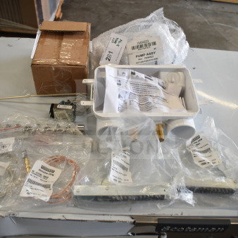 Nine new scratch and dent items including temperature sensors, thermocouple, door hinges, pump assembly, and valve with labels.