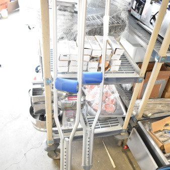 Pair of crutches with adjustable height, blue padding, and gray rubber tips; in good condition.