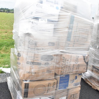 Pallet of 29 scratch and dent items, including hot cups, plates, bowls. Visible labels show Choice and Tork brands. Wrapped in plastic.