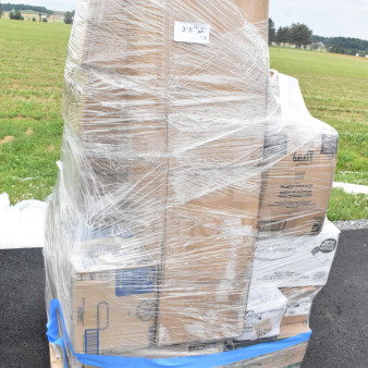 Pallet containing 26 boxes of scratch and dent items including cups and cutlery sets, wrapped in plastic with visible labels.