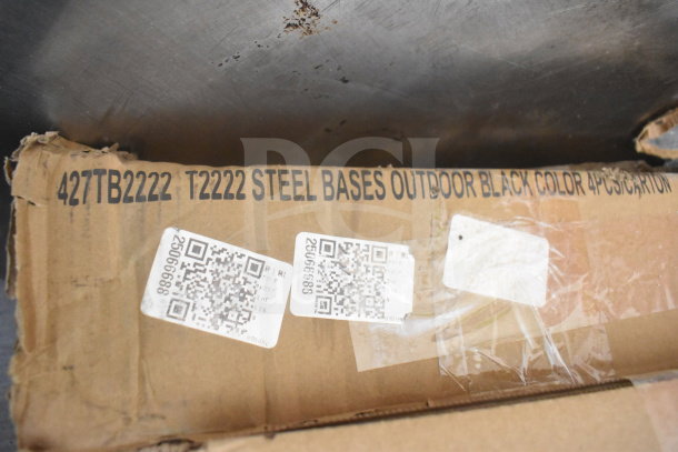 Cardboard box marked "427TB2222 T2222 Steel Bases Outdoor Black Color," with QR codes visible. Box shows wear.