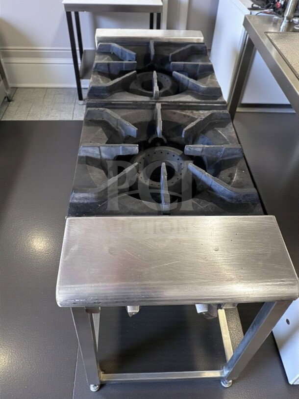 Prime condition, stainless steel 2-burner countertop gas hot plate with heavy-duty cast iron grates and manual controls.