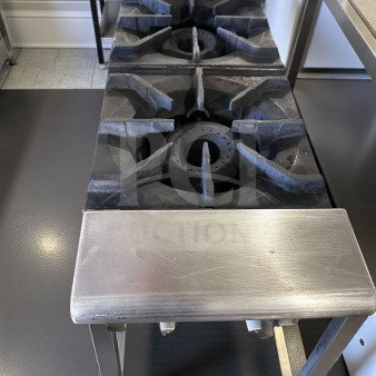 Prime condition, stainless steel 2-burner countertop gas hot plate with heavy-duty cast iron grates and manual controls.