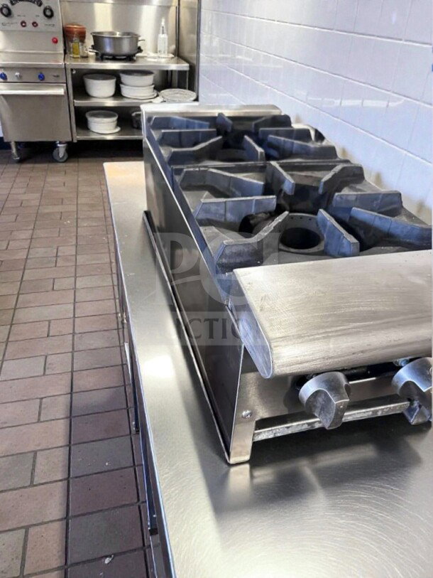 Stainless steel commercial 2-burner gas hot plate with heavy-duty cast iron grates and manual controls. Prime condition.