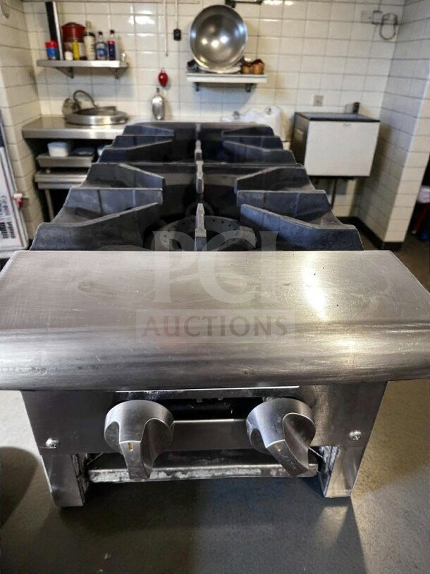 Prime condition 2-burner stainless steel gas hot plate with heavy-duty cast iron grates, manual controls, fully tested.