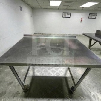 Stainless steel 46" x 30" mobile work table with wheels, well-maintained condition, ideal for commercial prep usage.