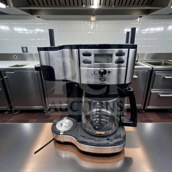 Brand new programmable 12-cup drip coffee machine in stainless steel and black, with glass carafe and single serve option.