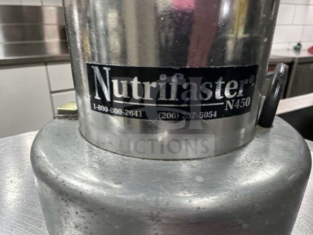 Nutrifaster N450 Commercial Juicer in stainless steel. Heavy duty, fully tested, high-performance. Model and contact info visible.