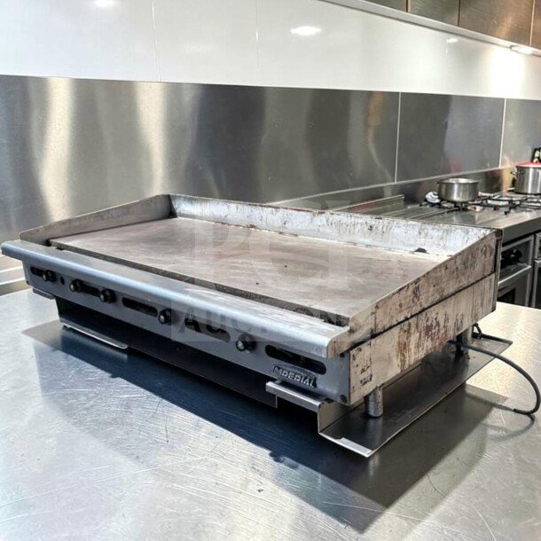 Imperial ITG-60 60" commercial gas griddle with 1" steel plate in superior condition. Features thermostatic controls; model IMP-L-GRID-0876.