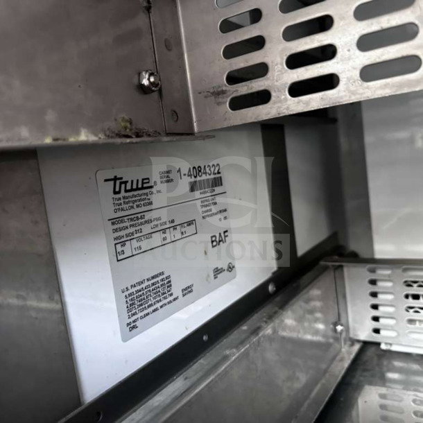 Close-up of True TRCB-52-HC label showing model details and specifications in stainless steel interior.