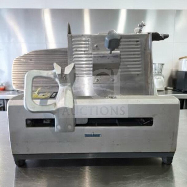 German Knife GS-12M, 12" commercial gravity feed slicer in exceptional condition, UL & NSF certified, 1/2 HP motor.