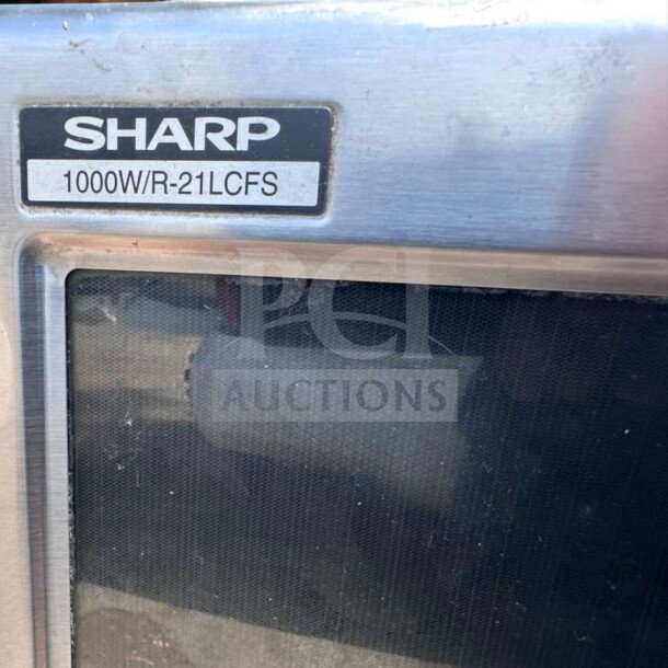 Sharp R-21LCFS 1000W commercial microwave, stainless steel, dial control, excellent condition, label visible.