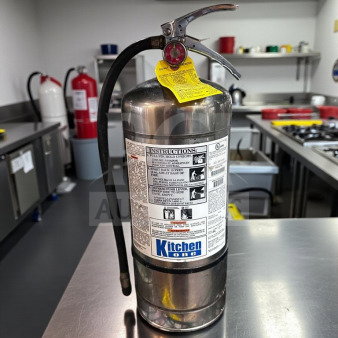 Pyro-Chem KS-6100 commercial Class K fire extinguisher, elite condition, UL listed, inspected, Kitchen One label visible.