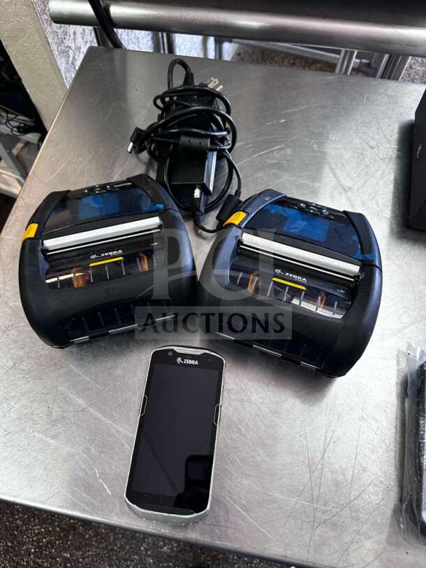Dual Zebra ZQ630 mobile thermal label printers, elite condition, fully tested. Includes charging cables and handheld device.