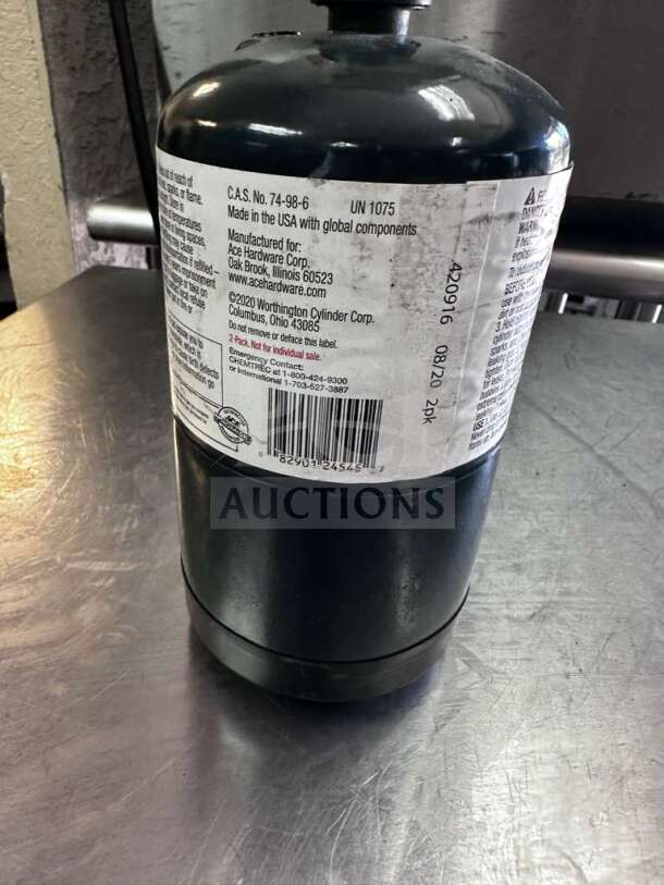 Ace Hardware 16 oz steel propane fuel cylinder in exceptional condition, featuring labels with safety and manufacturer details.